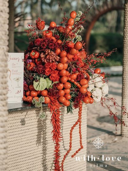 A close-up of the bar decor, with a cascade of cherry tomatoes and red flowers.