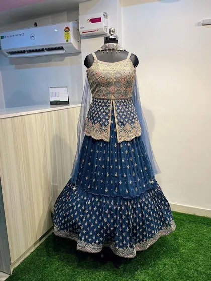 The complete look of the navy blue jacket lehenga set. It’s an elegant and unconventional rental piece that’s perfect for making a statement.