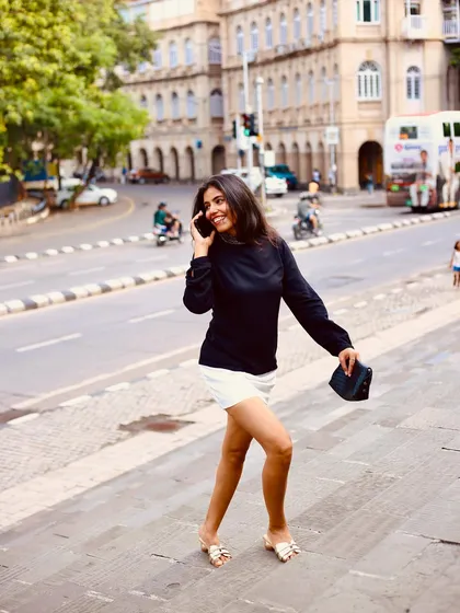 Even in a 'Femme Fatale' shoot, there's always room for fun. This candid shot of me breaking character on the phone shows the lighthearted, real moments that happen behind the scenes of every serious project.