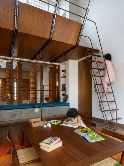 We designed this children's room with a suspended mezzanine loft, effectively doubling the usable space for play and sleep. The custom metal ladder adds a fun, interactive element, turning the room into a vertical playground.