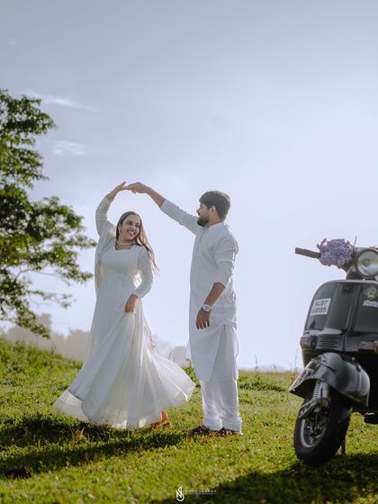 A beautiful silhouette-style shot of them dancing against the bright sky, creating a very artistic and romantic image.