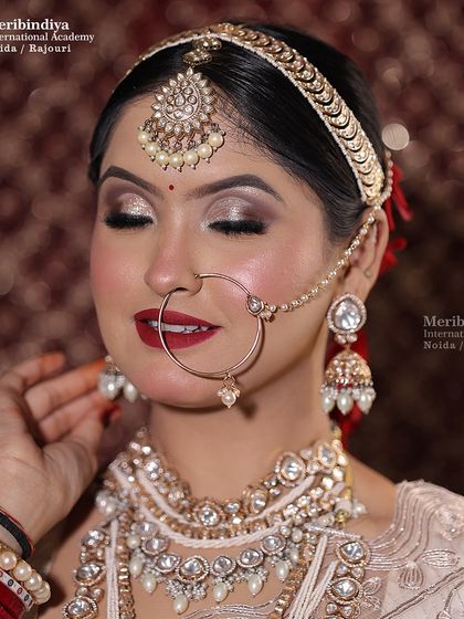 A close-up view of the metallic eyeshadow and classic red lip, demonstrating the precision and artistry required for high-impact bridal looks.