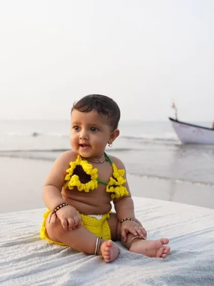 Capturing a perfect moment of sunshine and smiles. This photo, sent by a happy client, shows my handmade sunflower crochet bikini in action. Seeing my creations become part of such special family memories is why I love what I do.