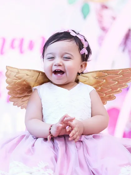 Look at that pure, unfiltered joy! We believe the best photos happen when kids are just being themselves. This is from a first birthday party, and this little angel's laugh made our day.