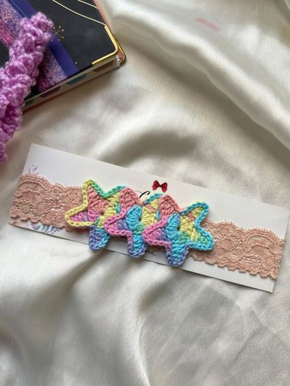 Another look at our delicate pastel star newborn headband, perfect for adding a touch of magic to your baby's outfit.