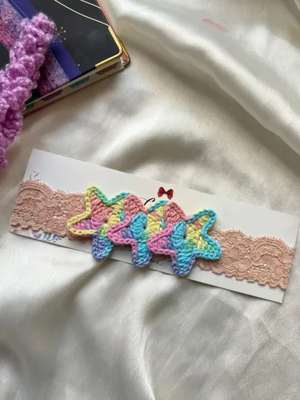 Another look at our delicate pastel star newborn headband, perfect for adding a touch of magic to your baby's outfit.