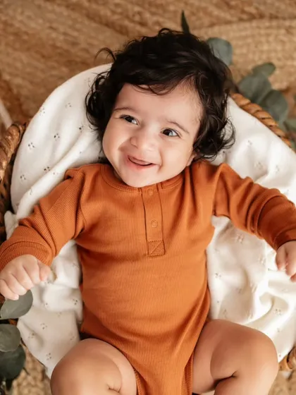 Look at that gorgeous smile! This is from a sitter session, perfect for babies around 4 to 6 months old. I use simple, safe props like this basket to keep the focus on their sweet expressions and new skills, like sitting up.