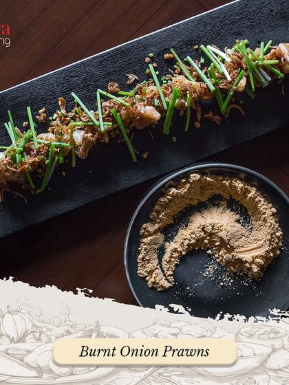 Our Burnt Onion Prawns are a unique and flavourful appetizer. The prawns are cooked with a special burnt onion seasoning and garnished with fresh chives.