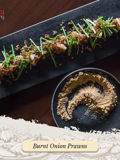 Our Burnt Onion Prawns are a unique and flavourful appetizer. The prawns are cooked with a special burnt onion seasoning and garnished with fresh chives.