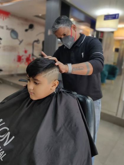Here's a look at my stylist creating a custom hair tattoo. These designs are a fun way for kids to express their personality with their haircut.