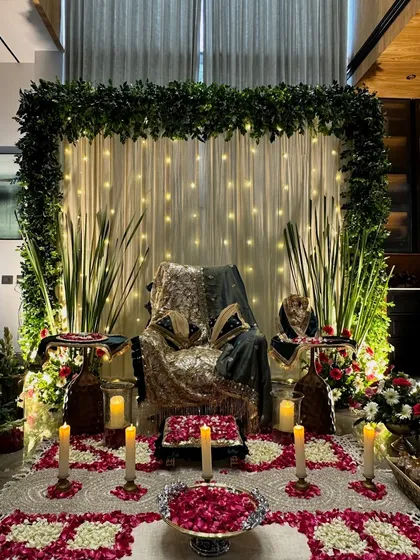 We create serene and beautiful setups for Guru Ji satsangs. This particular design features a lush green floral frame, a backdrop of soft fairy lights, and carefully arranged rose petals on the floor, creating a peaceful and blessed atmosphere for prayer and meditation.