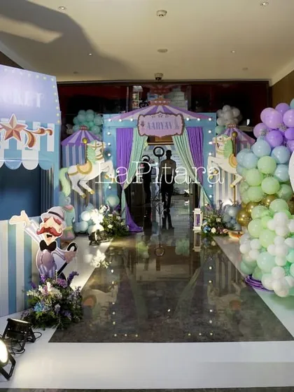 Step right up to this grand carnival entrance. This wide shot showcases the scale of the event, featuring a ticket booth, directional signs, and a hot air balloon photo op, all designed to create the nostalgic and exciting feeling of a classic carnival.