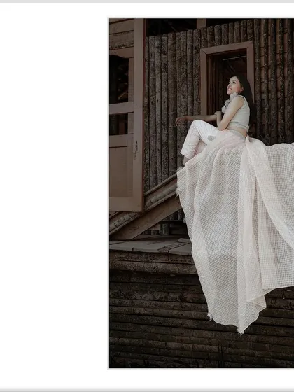 A cropped version of the elegant solo portrait, focusing on the bride to be's pose and the flow of her outfit.