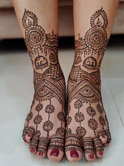 A playful and pretty foot design with hanging floral motifs and tiny elephants.