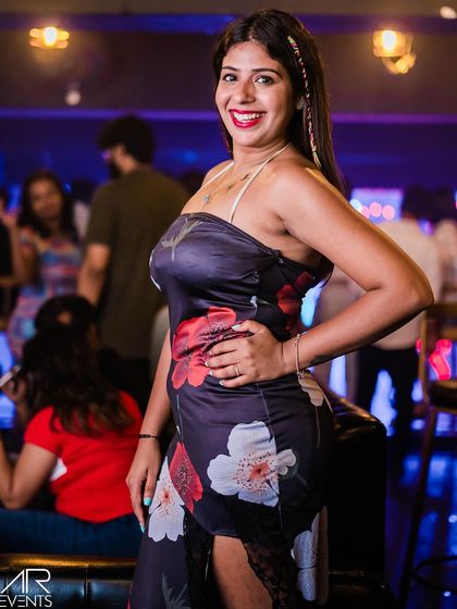 A guest in a floral dress, posing for the camera.