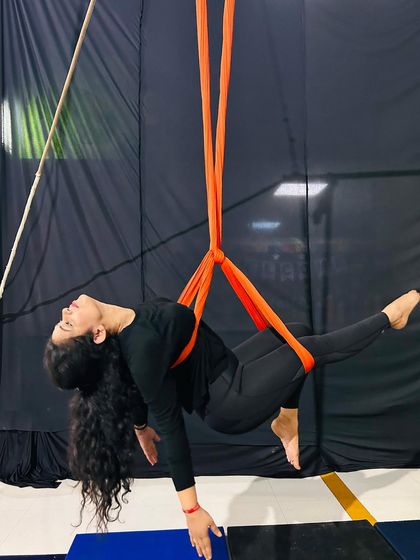 This side-cradle pose is both relaxing and a great way to build confidence while being fully supported by the silks.