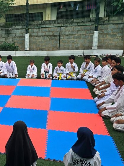 Students listening intently before a training drill. Discipline and respect are the foundations of our class.