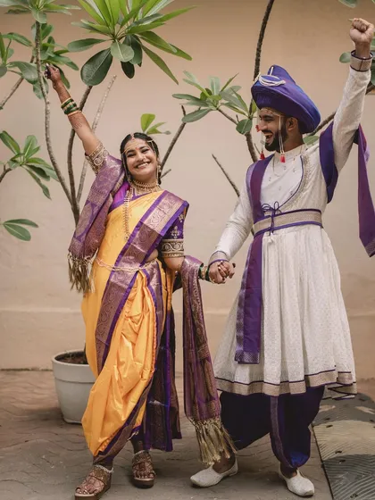 A fun and energetic shot of the Maharashtrian couple celebrating their union.