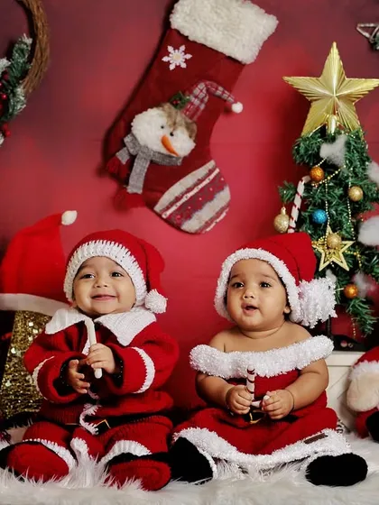 A Christmas-themed photoshoot with twins. Dressed in adorable Santa outfits, they are ready to celebrate their first holiday season together.
