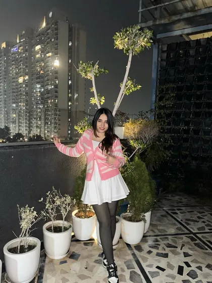 A playful pose showing off the full outfit. This look is sweet, stylish, and perfect for a casual date.