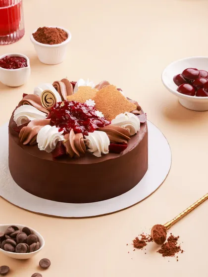 Our modern take on the classic Black Forest cake, with swirls of chocolate and vanilla cream, fresh cherry compote, and delicate wafer details.
