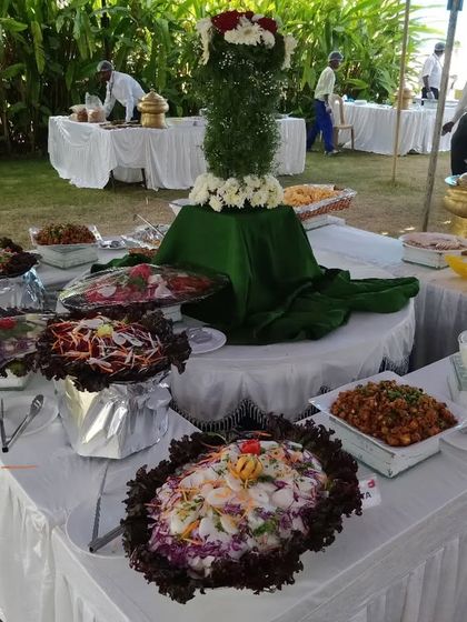 A vibrant salad bar at an outdoor event. We offer a variety of fresh, colorful salads and cold appetizers, beautifully presented to entice guests.