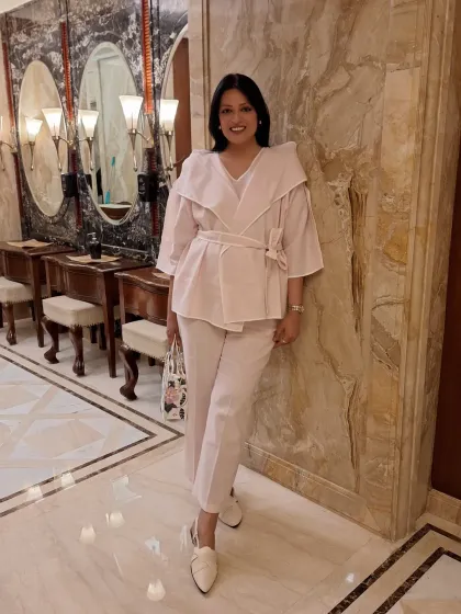 The full look of the pink co-ord set. Paired with white mules and a floral bag, it's a perfect spring or summer ensemble.