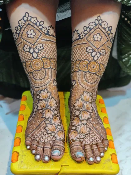 A heavy bridal leg design with intricate floral bands, lotus patterns, and detailed grid work.
