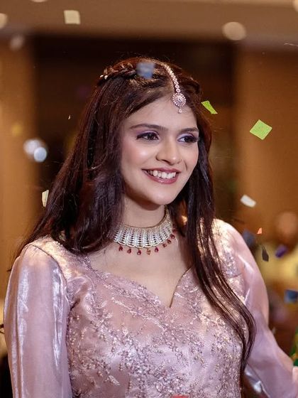 A joyful moment as the bride is showered with confetti. Her bright smile shows the happiness of being surrounded by loved ones.