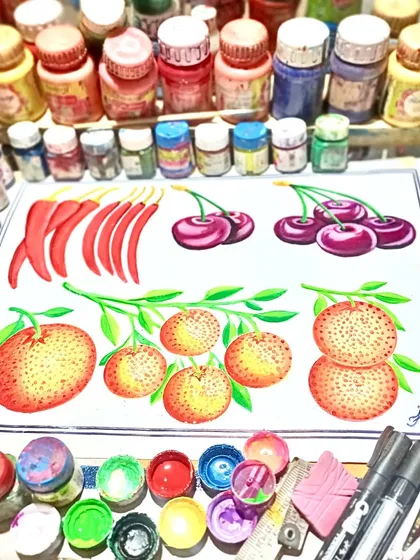 My workspace, showing a finished illustration of fruits and vegetables surrounded by my paints and brushes.