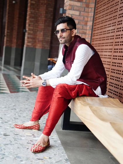 A moment of quiet contemplation before the event begins, dressed in vibrant traditional wear.