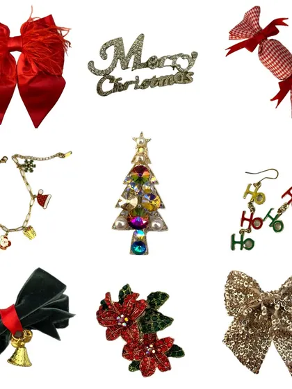 A festive flat-lay of our exclusive Christmas accessories. This image features everything you need to get in the holiday spirit, including red feather bows, "Merry Christmas" pins, tree-shaped brooches, and "HO HO HO" earrings.
