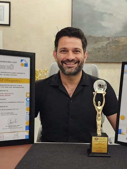 A photo of me with the two awards our firm received at the National Architecture and Interior Design Excellence Awards. These accolades inspire us to continue creating spaces that make a lasting impact.