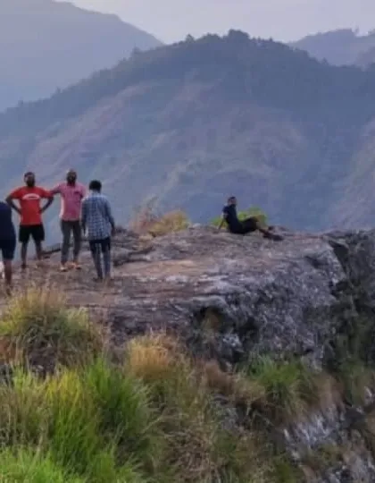 A group of friends enjoying the view from a cliff edge viewpoint during the Vattavada nature camp.