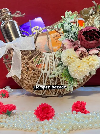 A beautiful half moon basket decorated with flowers and filled with treats. This unique design is perfect for gifting on Diwali or any other special occasion.