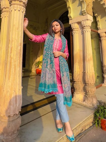Posing against the stunning architecture of the palace. The golden hour light makes the pink and teal of my ethnic outfit glow.