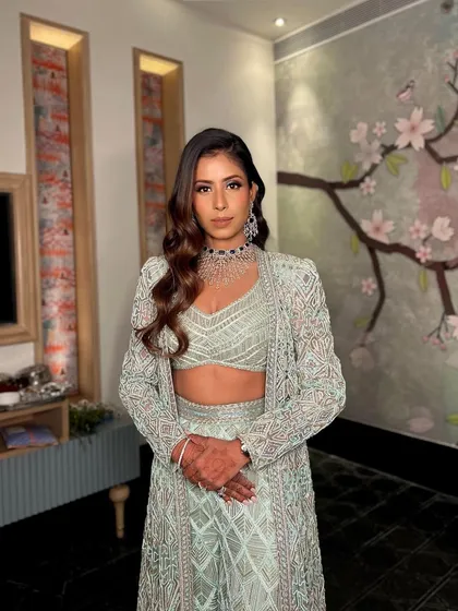 The side profile of this cocktail glam highlights the beautiful contour and the way the wavy hair frames the face. It's a look that is all about modern sophistication.