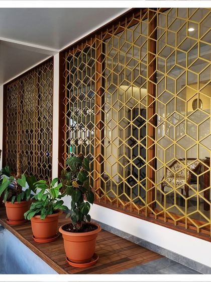A close-up of the custom-designed window grills with a golden finish, turning a security feature into a decorative element.