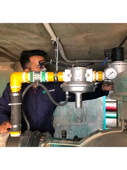 An engineer makes precise adjustments to the dual fuel conversion kit. This image highlights the technical expertise involved in ensuring every installation is optimized for safety and peak performance, transforming existing grid infrastructure.