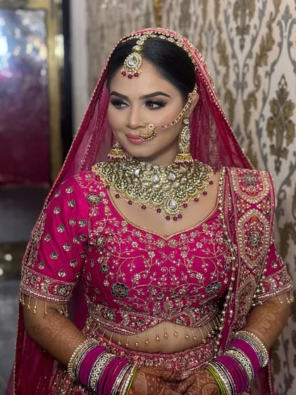 A classic bridal pose showing off the intricate details of the makeup and jewellery. The look is timeless, with a focus on glowing skin and elegantly defined features.