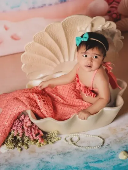 Our little mermaid resting in her seashell. This whimsical under-the-sea theme creates magical and dreamy portraits.