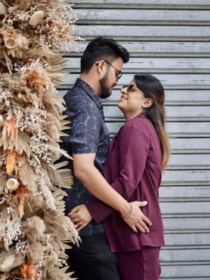 A modern and chic pre-wedding look. The makeup is sophisticated, with a focus on flawless skin and defined features.