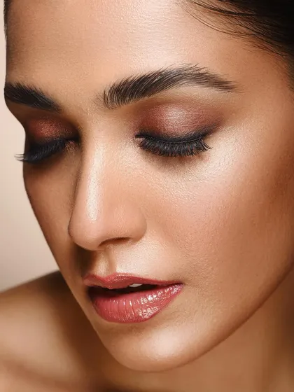This shot captures a moment of tranquility. With her eyes closed, the focus shifts entirely to the beautiful eyeshadow application and the model's serene expression, showing a softer side of beauty portraiture.