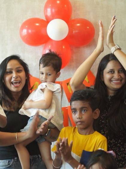 The pure joy of a birthday celebration is what I strive for. Here, family and friends clap and cheer during a party, creating a warm and festive atmosphere for the little one.