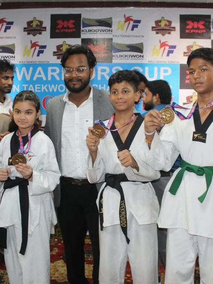 Students posing with their medals at the Warriors Cup. Each medal represents a personal victory and a step forward in their competitive journey.