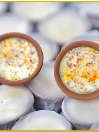 Individual servings of a creamy Indian dessert, possibly phirni or rabri, presented in charming clay kullads for an authentic touch.