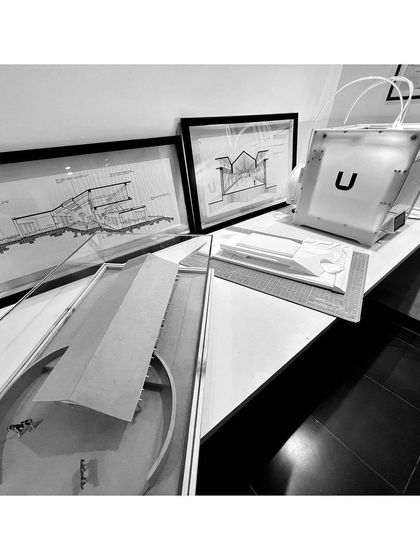 A glimpse into our studio, where hand-drawn perspectives from decades ago coexist with 3D printers and new models. This space is a testament to our evolving, multi-faceted design process.