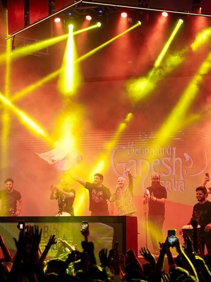 The stage lit up with yellow lights during our performance at the Ganesh festival.