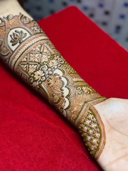 The design continues to extend down the arm, with more layers of patterns being added.