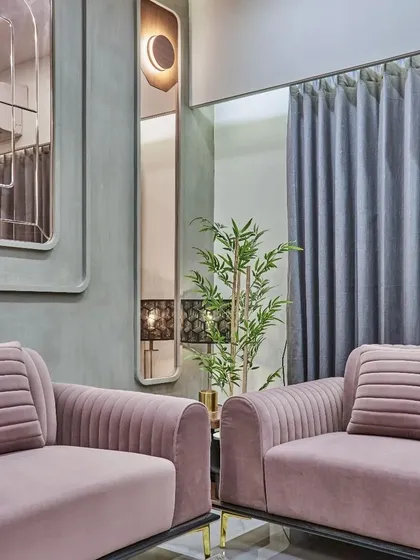 A vertical mirror with an integrated light fixture adds a touch of art deco elegance and helps to visually heighten the space.